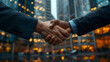 © PLATİNUM - Close-up view of a corporate handshake in front of a modern office building