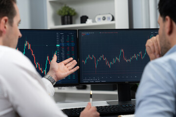 Wall Mural - Stock traders discussing on research market stock database at real time by using two pc screen for comparing with the past of valued and current exchange analyzed business dynamic by minute. Sellable.