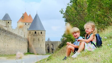 Wall Mural - Little adventurers take a rest by historic fortress Carcassonne