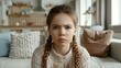 Young girl with braided hair looking upset and concerned.
