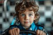 Young child in racing suit gripping a steering wheel with focus and determination