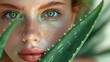 Portrait of a young woman with green eyes and light green makeup and lipstick, slightly open, abstract background filled with aloe vera leaves with copy space, beauty concept. Generative AI.