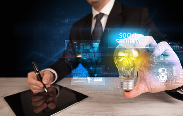 Poster - Businessman holding a light bulb, online security concept