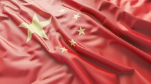 A Beautiful Flag Of China With A Red Background And Five Gold Stars. The Flag Is Waving In The Wind And The Folds Of The Fabric Are Visible.