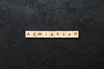 ADMISSION word written on wood block. ADMISSION text on cement table for your desing, concept