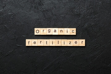 organic fertilizer word written on wood block. organic fertilizer text on cement table for your desing, concept