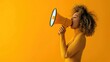 A young woman yelling in a megaphone on a vibrant yellow background, real photo