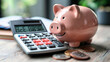 Piggy bank with a smile on a calculator, symbolizing financial planning and savings.