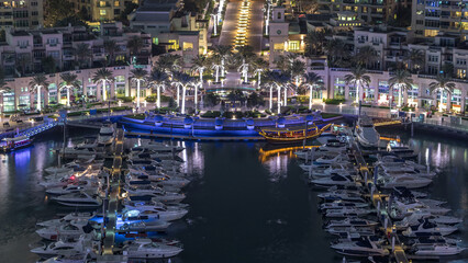 Wall Mural - Dubai Marina fountain aerial night timelapse, port with luxury yachts and marina promenade