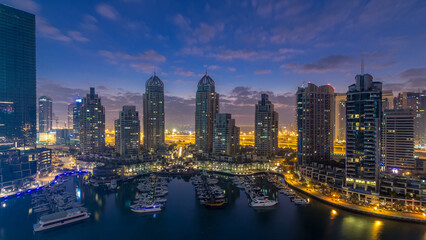 Wall Mural - Aerial view of modern skyscrapers night to day timelapse before sunrise in Dubai Marina in Dubai, UAE.