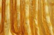 Golden textured fabric with draped folds