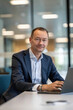 © Synthetica - Middle aged business man executive financial investor sitting at desk using laptop. Busy professional businessman ceo manager working on computer corporate technology in modern office. Portrait.