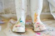 painters white boots with paint splatter on a drop cloth