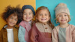 Cheerful children of different ethnicities in diversity photo shoot on soft color background.