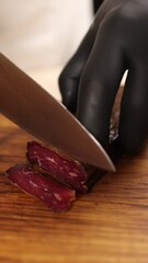 Wall Mural - A chef slices meat in a restaurant.  Close-ups 