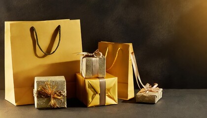 Wall Mural - gift bags and boxes wrapped in yellow paper on black background with copyspace