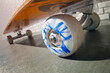 Close-Up Dynamic Spin: Skateboard Wheel in Motion Against Urban Backdrop