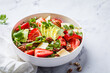 Strawberry and avocado salad with arugula, parmesan, nuts and lemon zest.