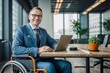 © polack - Disabled European businessman in a suit and wheelchair, smiling and working with a laptop in a modern office