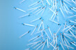 Multiple Disposable Medical Syringes Spread on a Vivid Blue Background