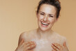 smiling modern female rubbing body cream