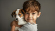 A cute portrait of a young boy holding his beloved puppy