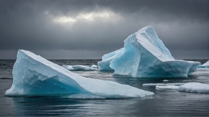 Thawing icebergs with drops of water falling into the sea