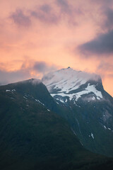 Wall Mural - Mountain sunset landscape in Norway  scandinavian nature snowy peak and clouds travel beautiful destinations northern nature evening atmospheric scenery