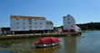 Woodbridge Quay and Tide Mill with boat on the river Deben.