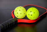 Fototapeta Dziecięca - Pickleballs and paddle. The sport of pickleball has become very popular in the last several years.
