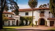 Historic Spanish revival mansion with clay tile roof arched windows and courtyard entry.