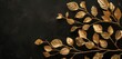 A branch adorned with shimmering gold leaves stands out against a stark black background, creating a striking contrast