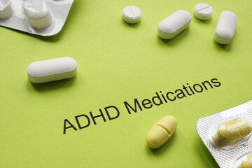 Wall Mural - Green sheet of paper with an inscription ADHD medications and pills.