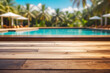 Wooden table pool bokeh background, empty wood desk product display mockup with blurry tropical hotel resort abstract poolside summer travel backdrop advertising presentation. Mock-up, copy space