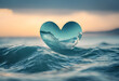 Transparent heart-shaped object floating on ocean waves at sunset, symbolizing love and nature's beauty.