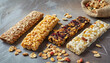Close-up of various granola bars on gray table. Cereal granola bars. Delicious snack. Top view.