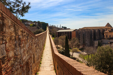 Wall Mural - Girona old city wall fortification, venerable 9th-century city walls with walkways, towers and scenic vantage points of city views of Girona, Catalonia, Spain