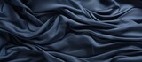 Fototapeta Przestrzenne - A close up of a sleeve made of electric blue satin fabric with a pattern resembling water droplets. The liquidlike texture shines in shades of purple, violet, and grey