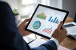 © JMDuran Photography - Analyzing Financial Data on Tablet. Close-up of a professional analyzing complex financial data and graphs on a digital tablet.