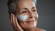 Graceful Aging: Mature Woman with Moisturizing Cream on Face