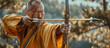 Focused Asian Monk In Traditional Clothing Shooting A Bow And Arrow In The Forest
