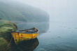 Solitary Yellow Boat on Misty Waters with Green Hills Banner