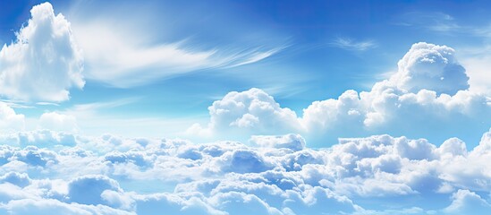 Wall Mural - clouds are visible in the sky against a backdrop of a clear, blue sky with fluffy, white clouds