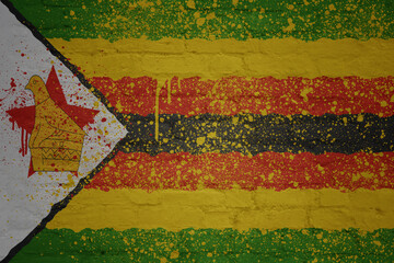 Wall Mural - colorful painted big national flag of zimbabwe on a massive brick wall