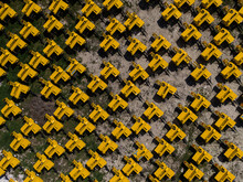 Aerial View Of The Storage Area Of Yellow Coloured Balers Produced By A Factory.