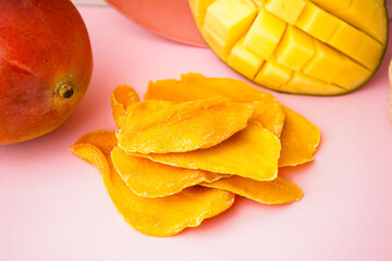 Wall Mural - Slices of dried mango on pink table