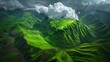  an aerial view of a mountain range with clouds in the sky and green grass in the foreground and a green valley in the foreground.