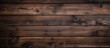 Capture a detailed image showing a wooden wall stain in a rich dark brown hue for a rustic and textured look