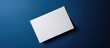 A blank white piece of paper on a dark blue background.