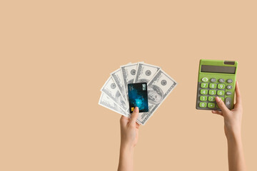 Poster - Woman with credit card, calculator and dollar banknotes on beige background